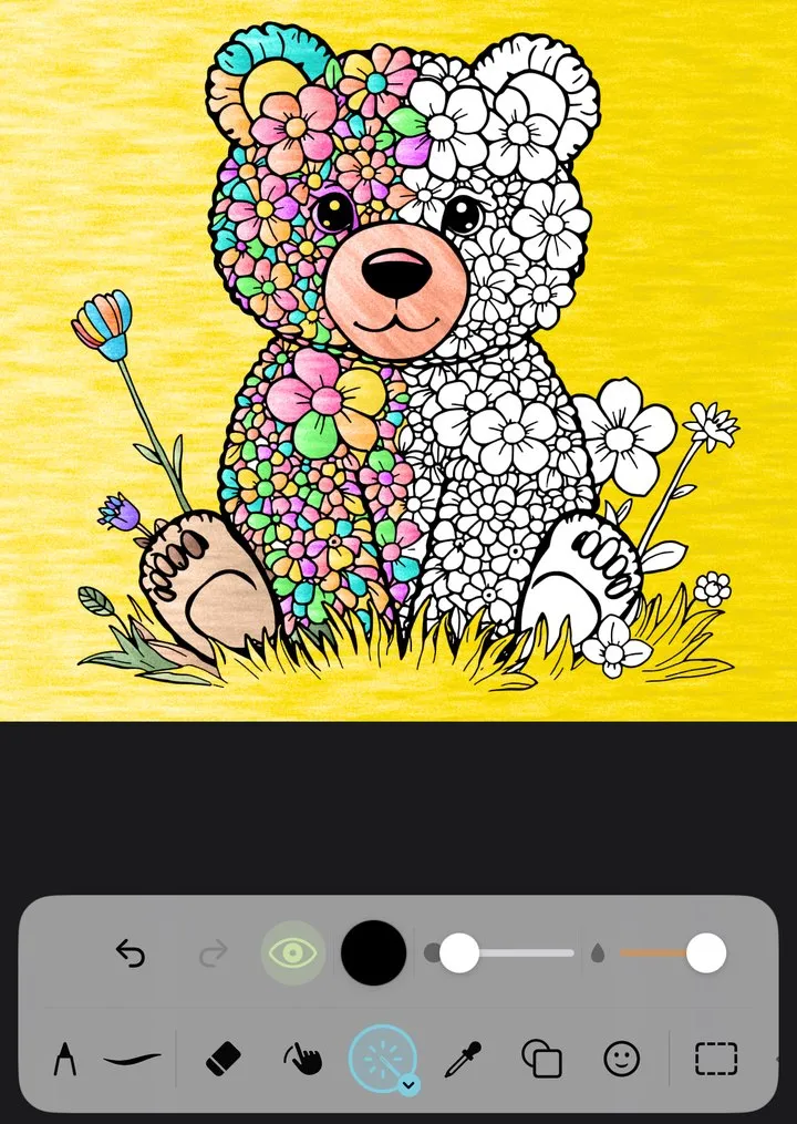 The bear cub half colored on the canvas, with the brushes below